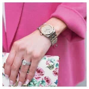 The AP  watch on the arm of a woman holding a bag