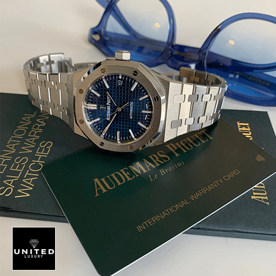 Audemars Piguet Royal Oak Blue Dial  side view next to warranty card