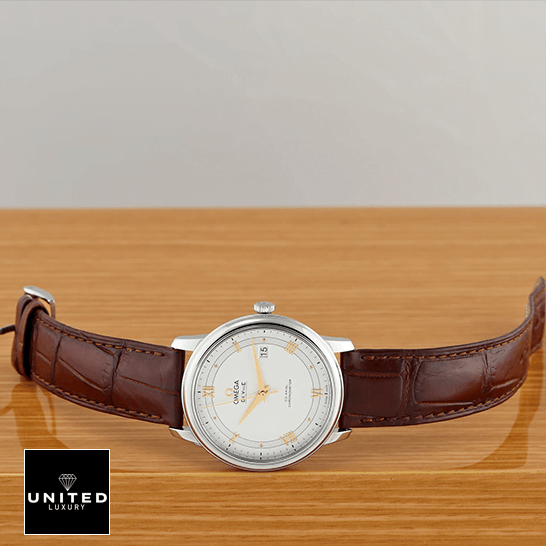 Omega De Ville Prestige White Dial Brown Leather Bracelet  on the table