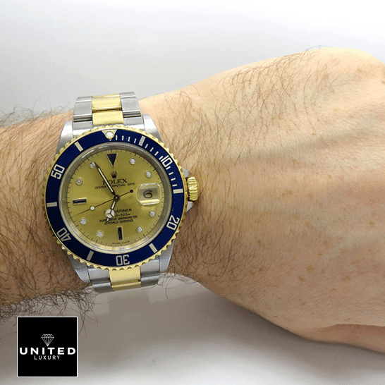 Rolex Submariner 16613 Yellow Gold Dial Blue Bezel  on his arm