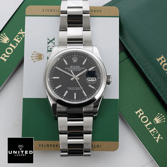 Rolex Datejust 115200 Black Dial  next to warranty card