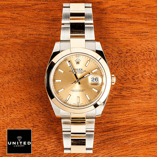 Rolex 126303 Oyster 2 Rolex Datejust 126303 Gold Dial on a wooden table