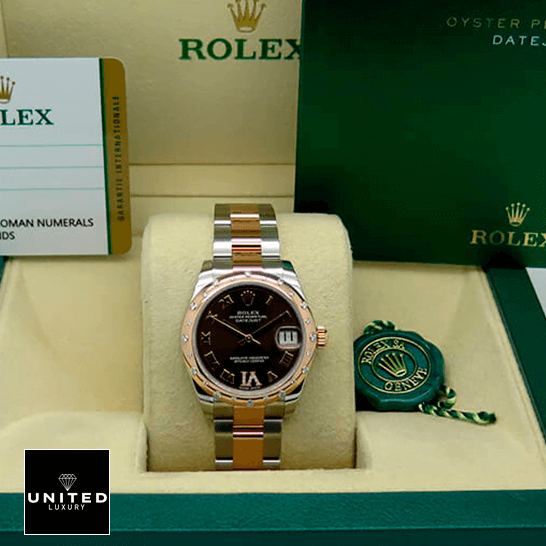 Rolex Datejust178341 Chocolate Roman  warranty card in the box next to it