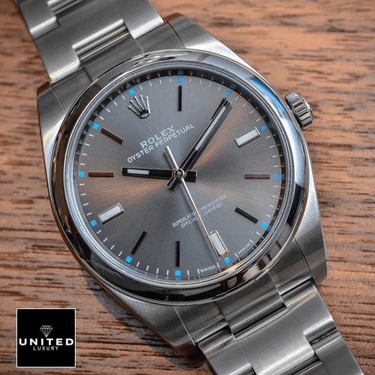 Rolex Datejust Perpetual 114300  dial is a dark rhodium grey with luminescent hands and hour markers