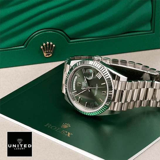 Rolex Day-Date 228239-0033 Romen Numerial Olive Green Dial  in front of Rolex Box