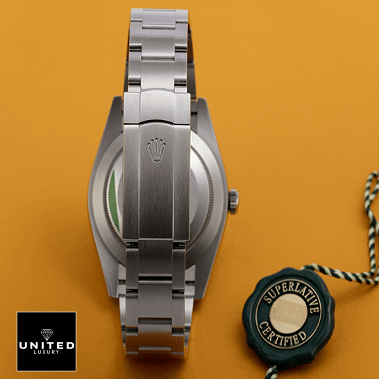 Rolex Perpetual 124300 Stainless Steel Oyster Bracelet  Fold Clasp on the Rolex Logo and Orange Background