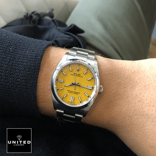 Rolex Perpetual 124300 Yellow Dial Stick indices  on his arm